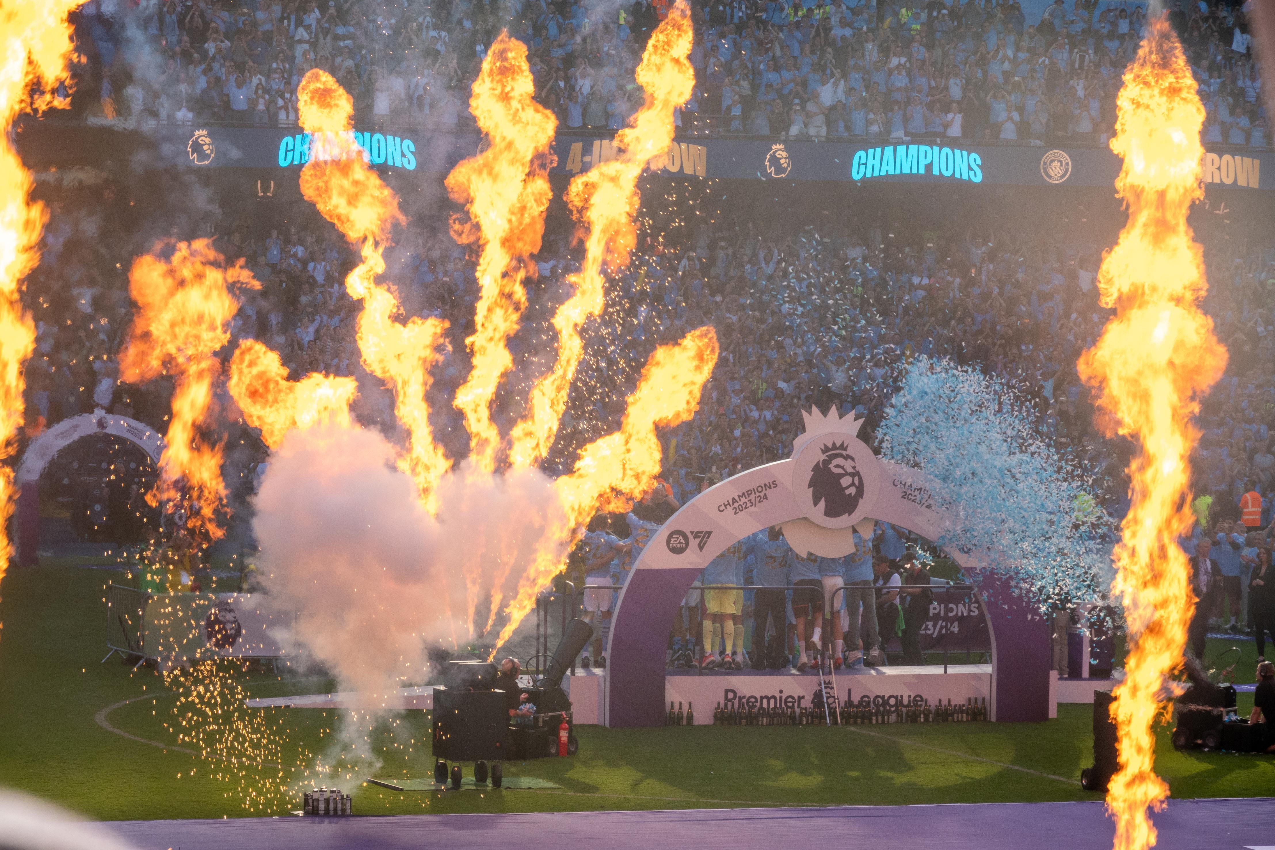 Celebratory fireworks and smoke at a sports event, with a trophy display in the background.